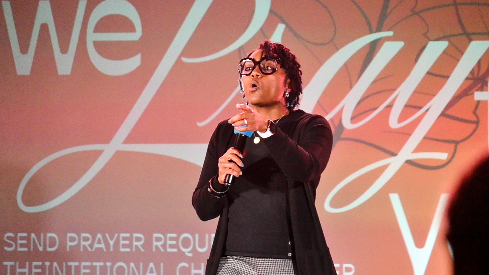 Regina Guidry praying with the church